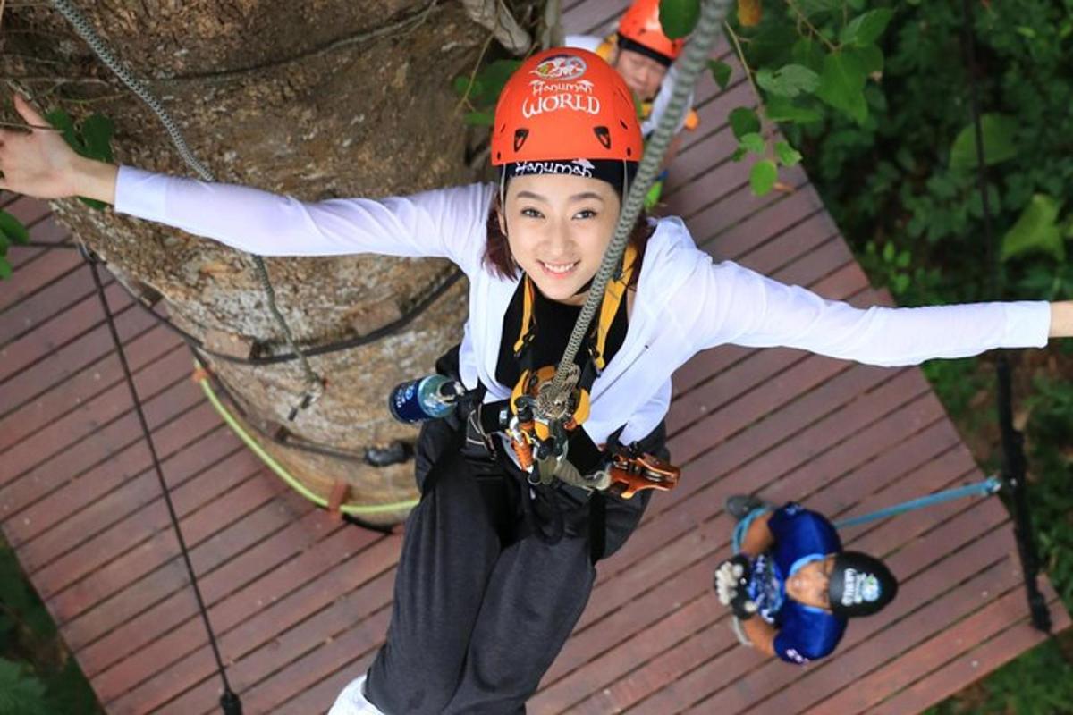 a young girl sitting on a rope swing