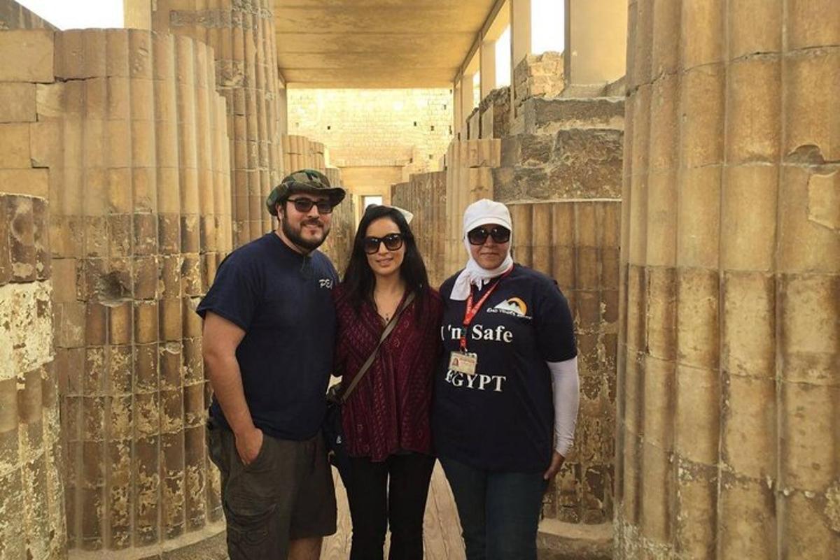 a group of three people standing in aiseum