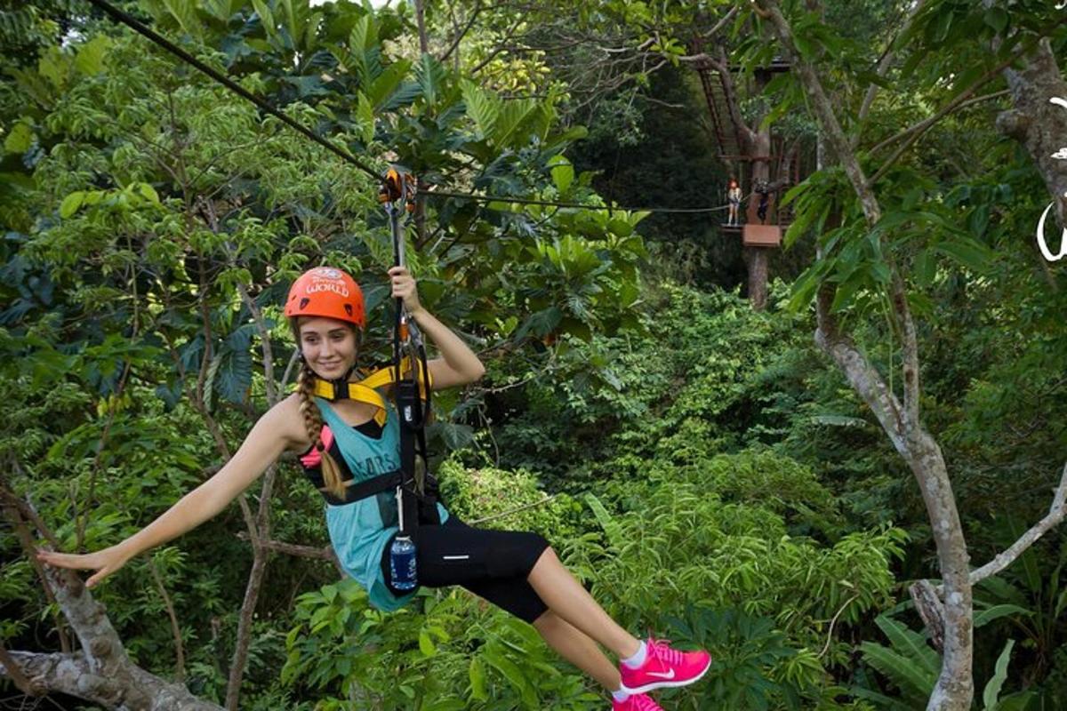a woman on a zip line in the jungle