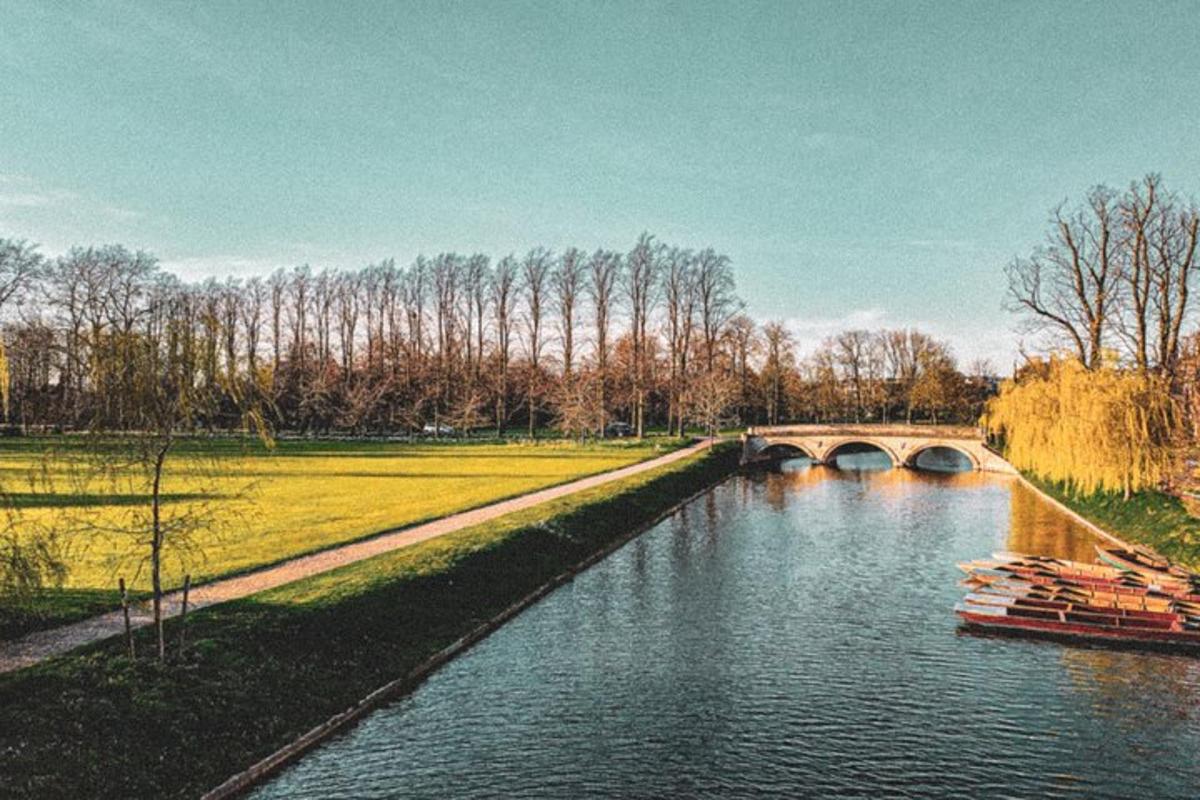 a river with a bridge and a boat in the water