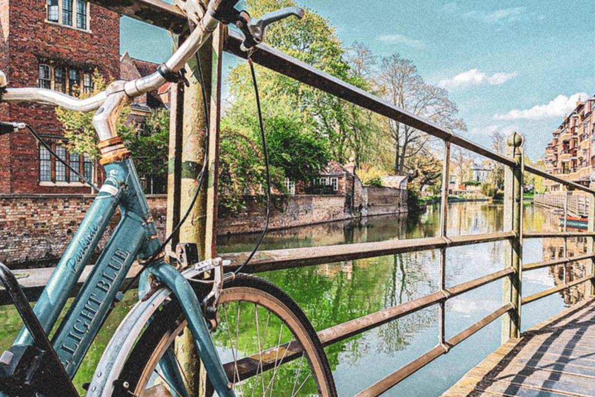 a bike parked on a bridge next to a river
