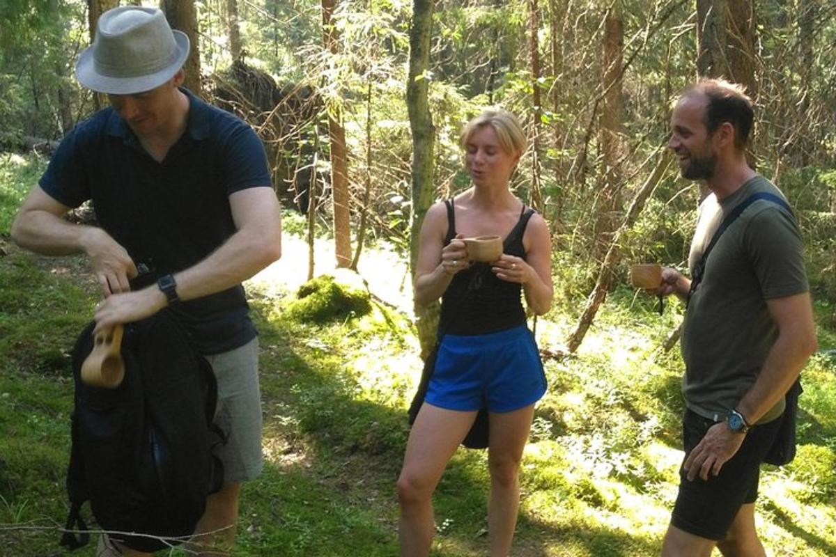 two men and a woman standing in the woods