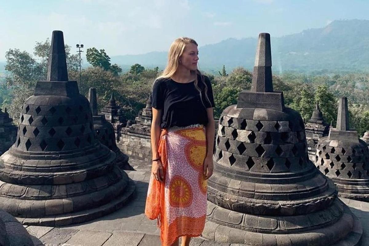 a woman standing on top of a temple