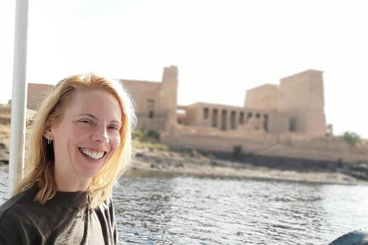 una donna in piedi accanto a uno specchio d'acqua