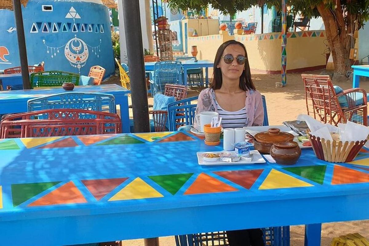 una donna seduta a un tavolo davanti a un tavolo blu