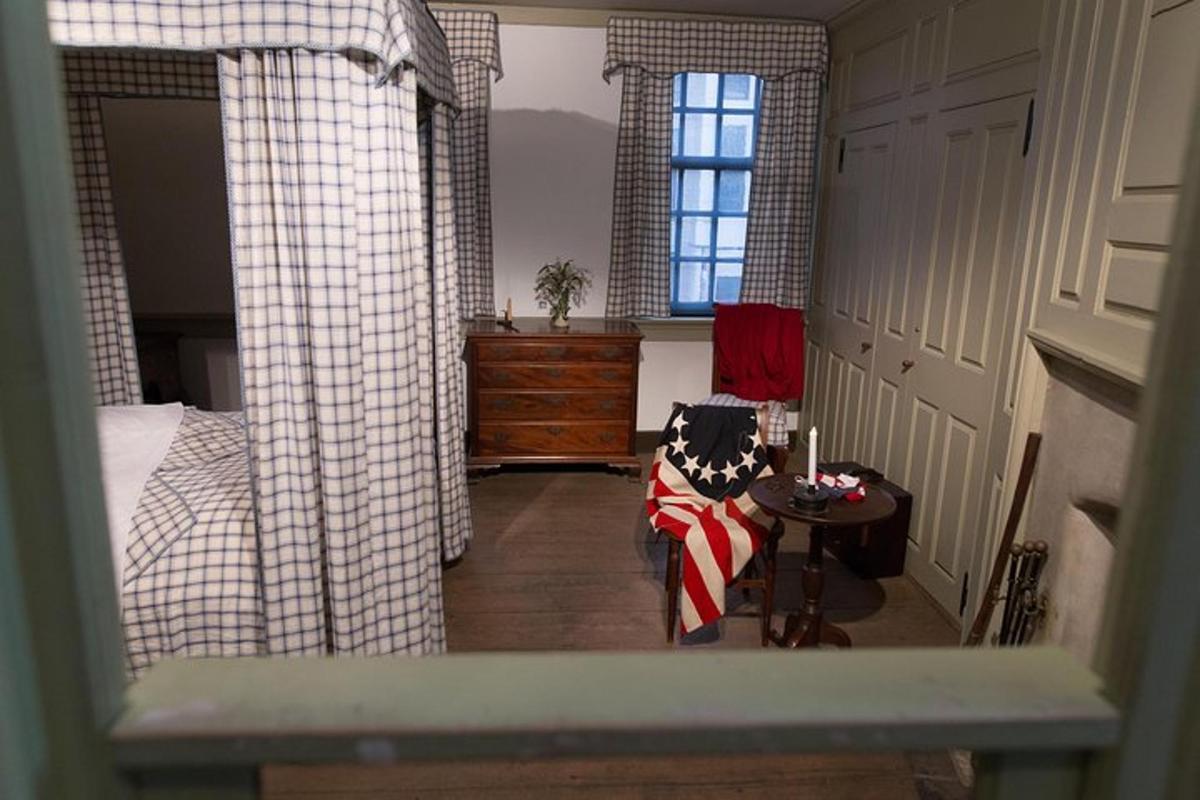 a bedroom with a bed and a table and a chair