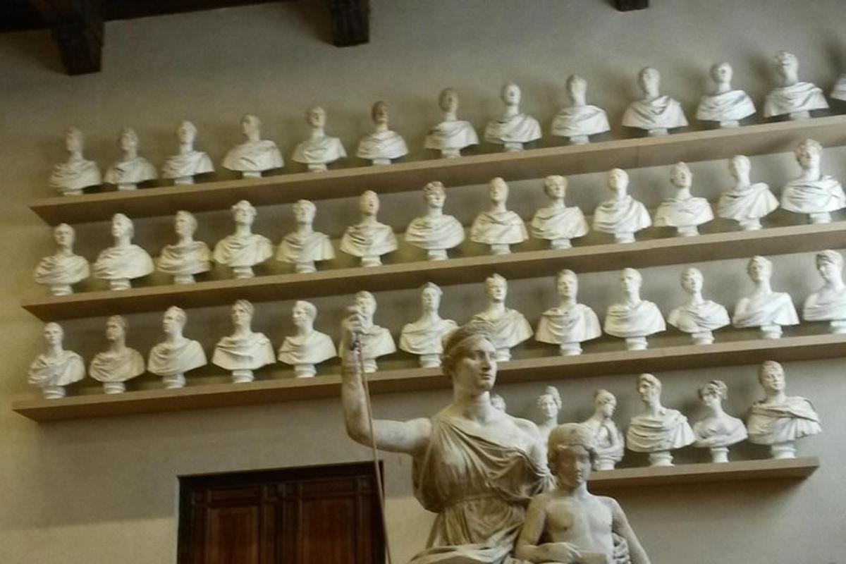 a statue of a woman and a child in front of a display ofulptures
