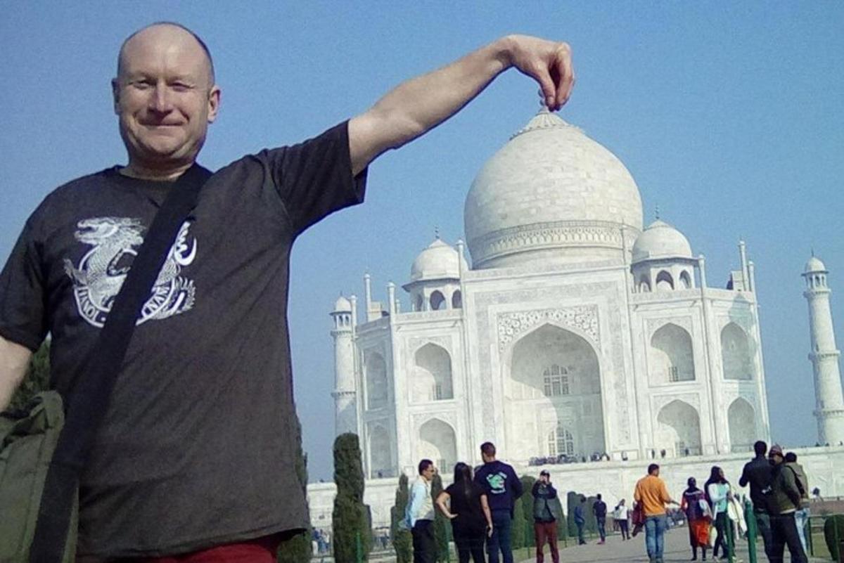 a man standing in front of the taj mahal