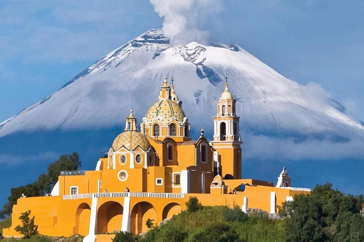 an orange church with a mountain in the background
