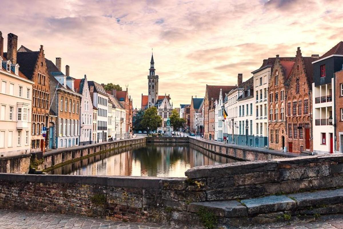 a river in a city with buildings and a clock tower