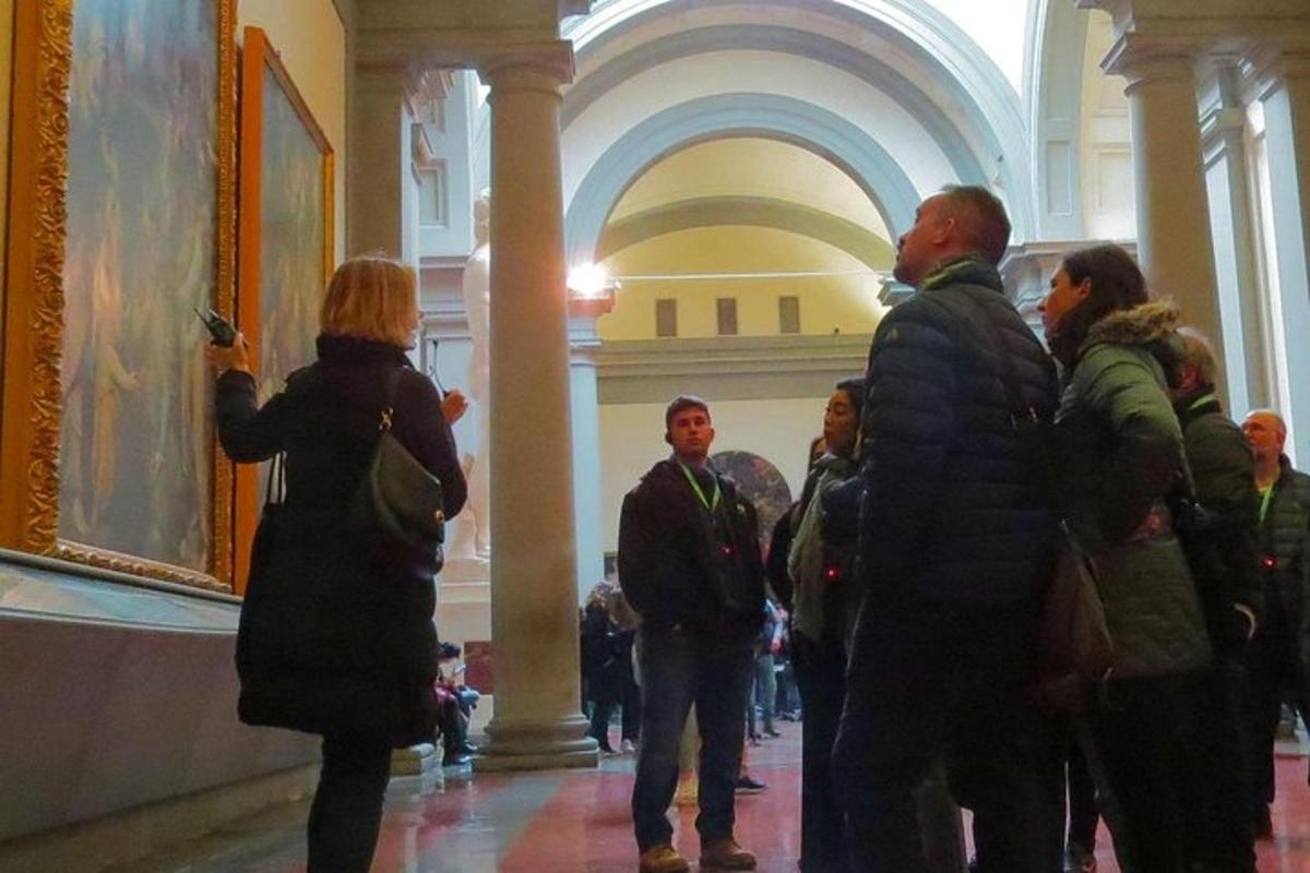 a group of people looking at a painting in a museum
