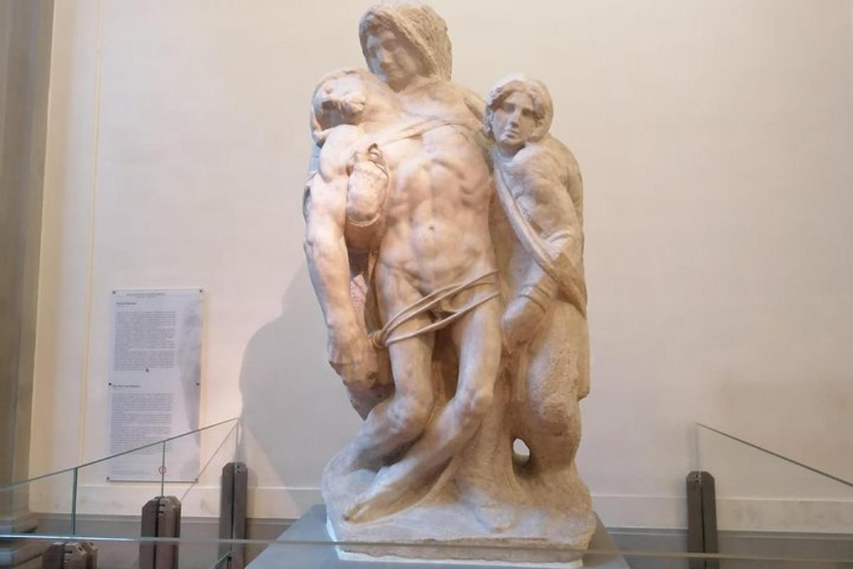a statue of two men on display in a museum