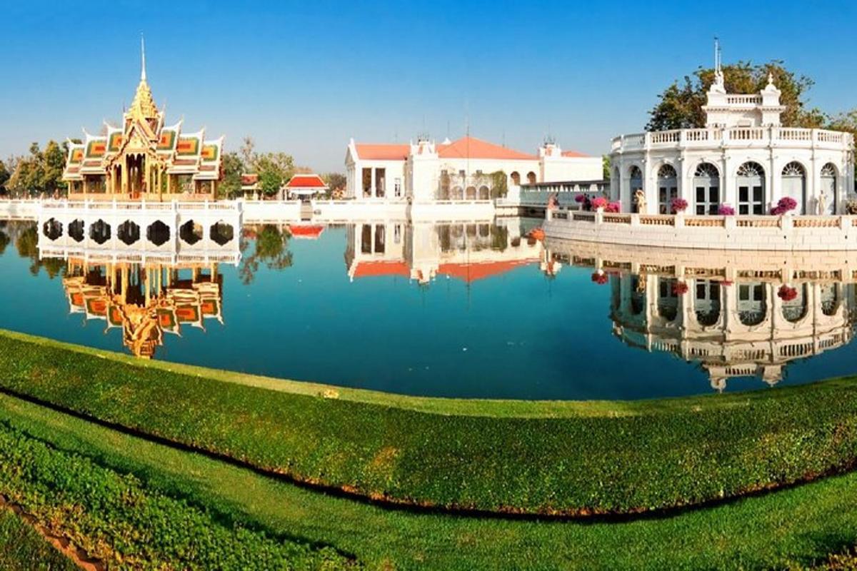 a reflection of a building in a lake in a park