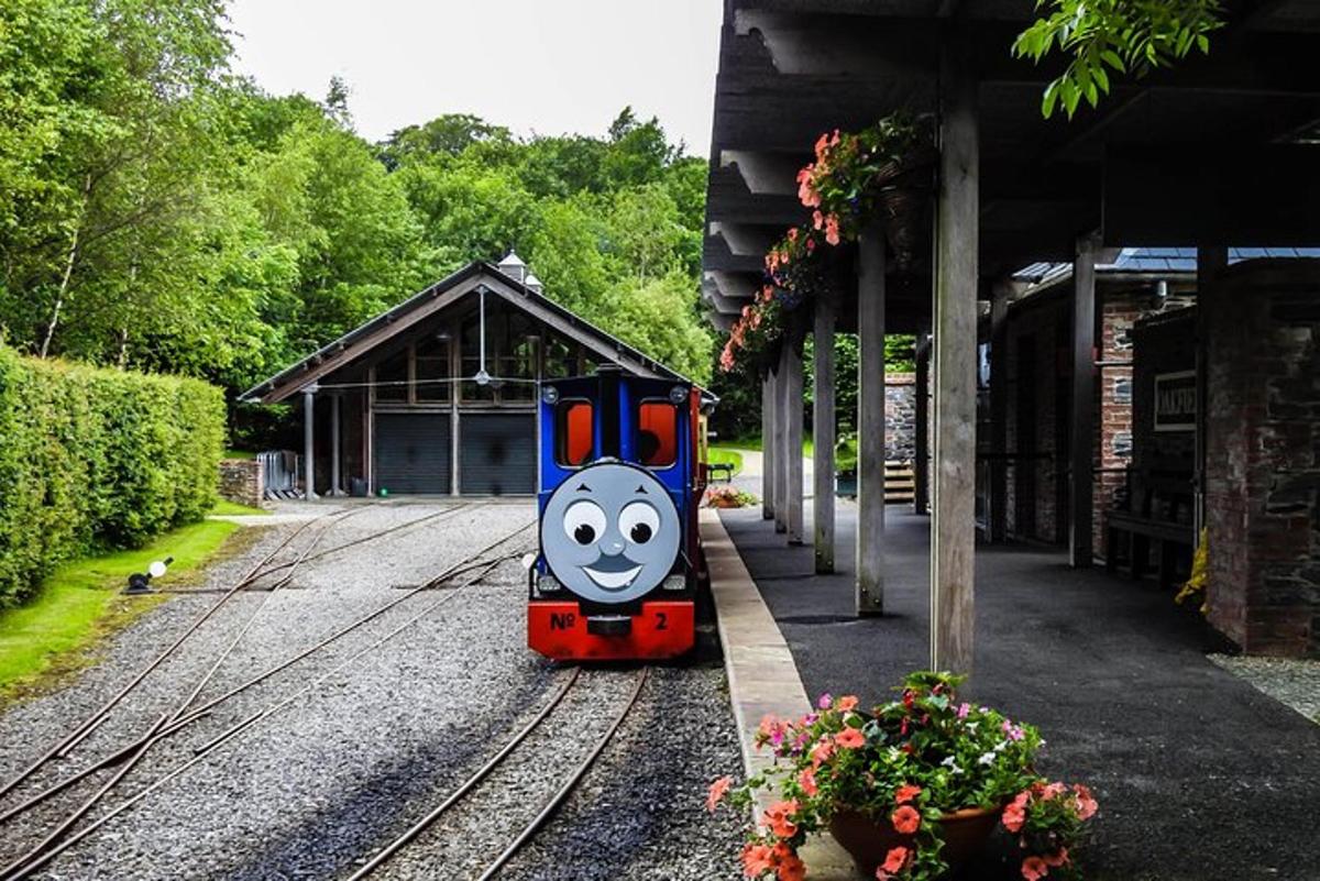 a toy train with a face on the tracks