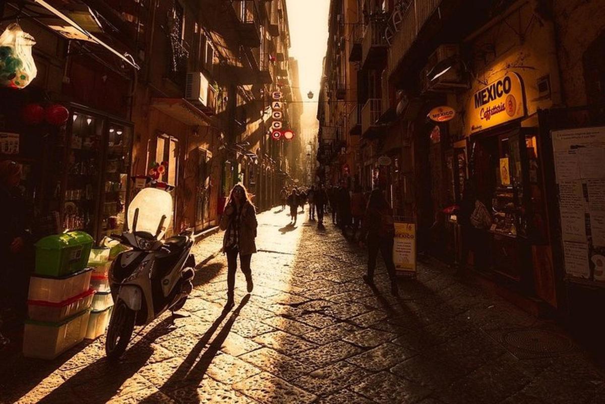 a person walking down a street with a motorcycle