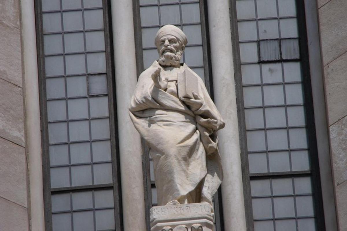 una estatua de un hombre en el costado de un edificio