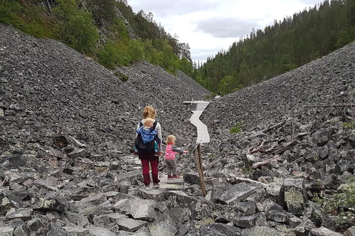 a woman and a child standing on a rocky hill