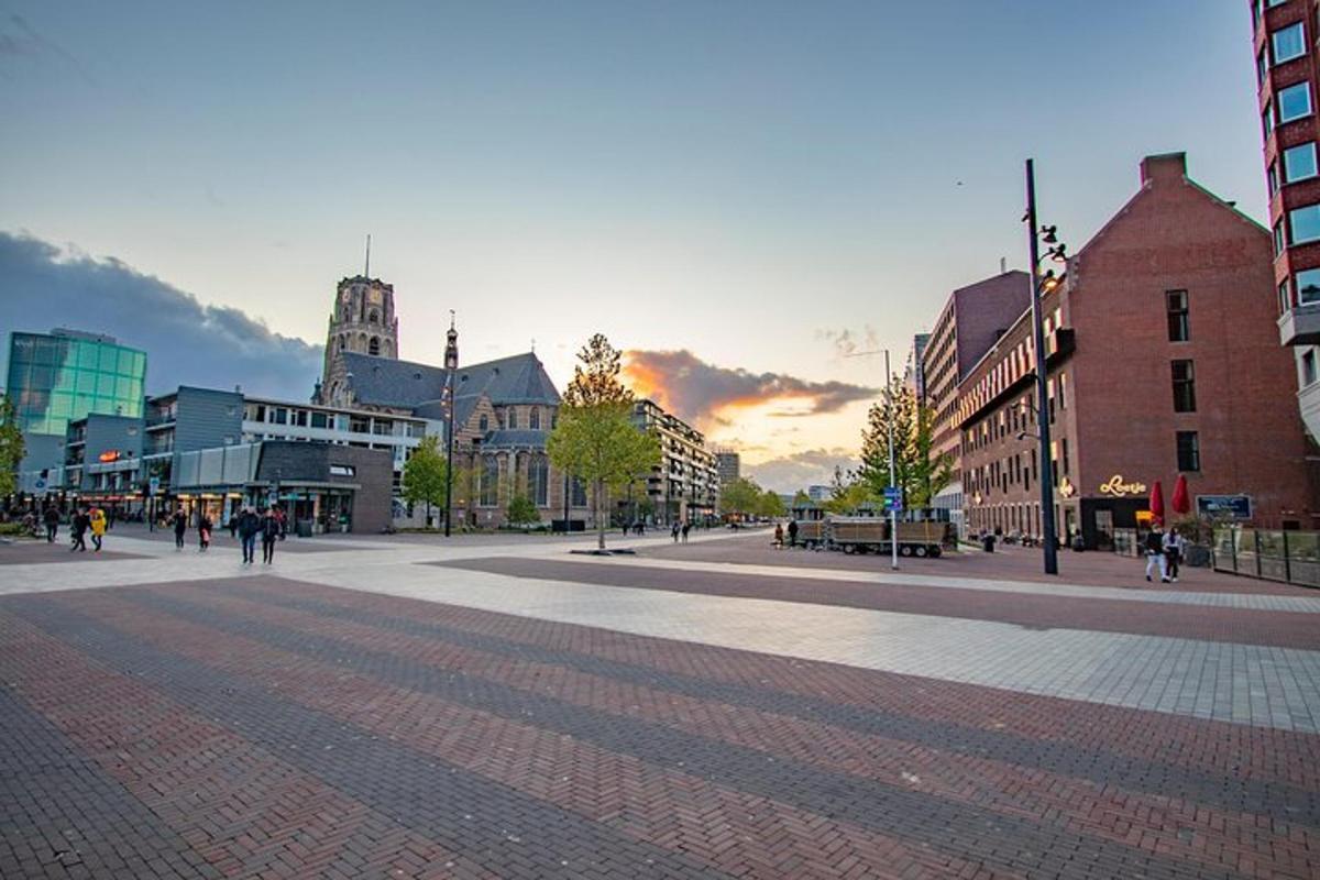 a city street with people walking on a brick road