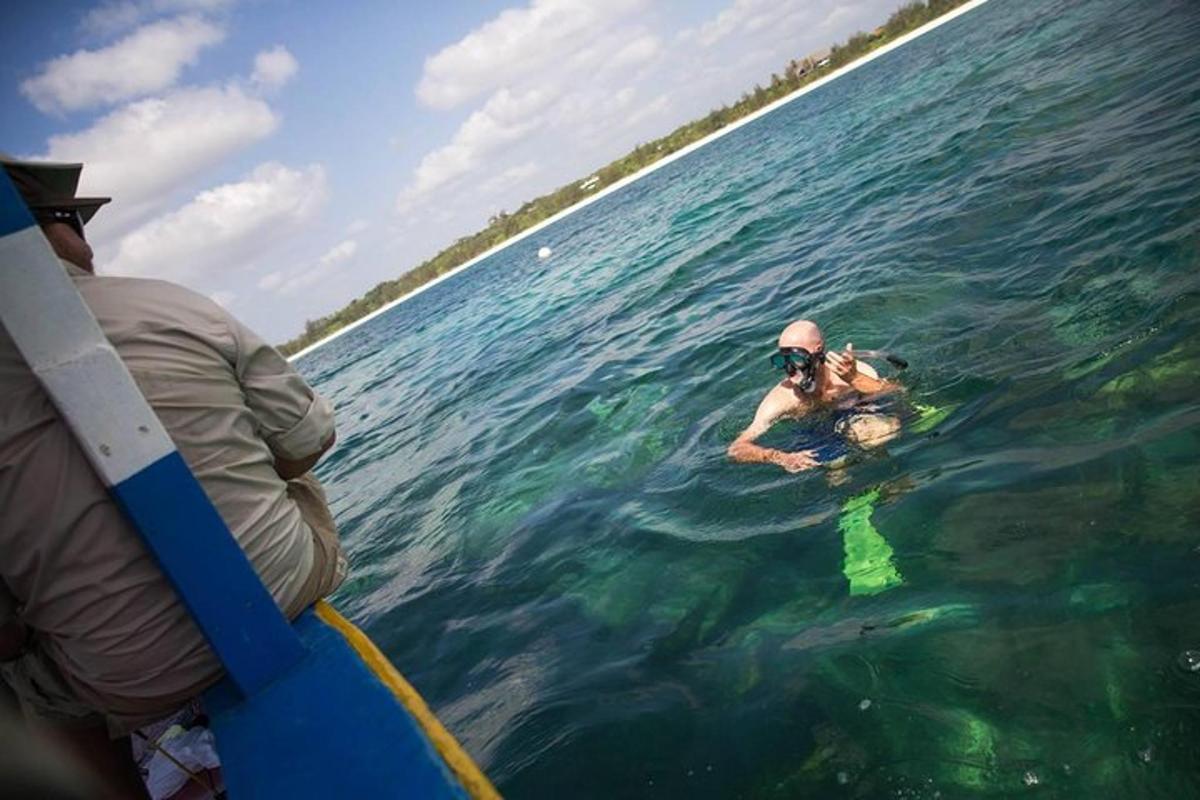 two people are in the water on a boat