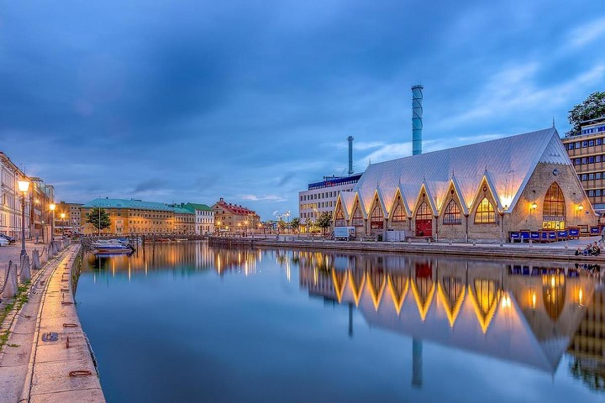 a large building next to a river with buildings