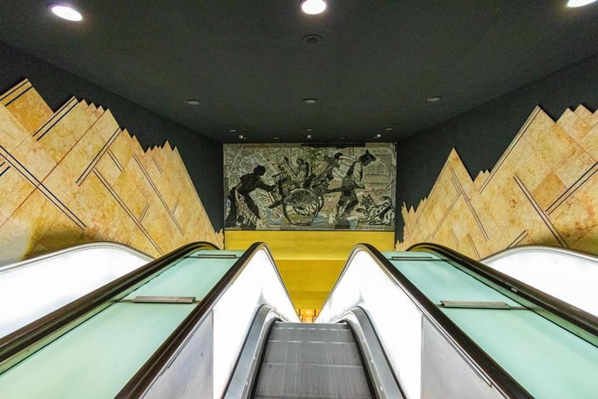 an escalator in a building with a painting on the wall
