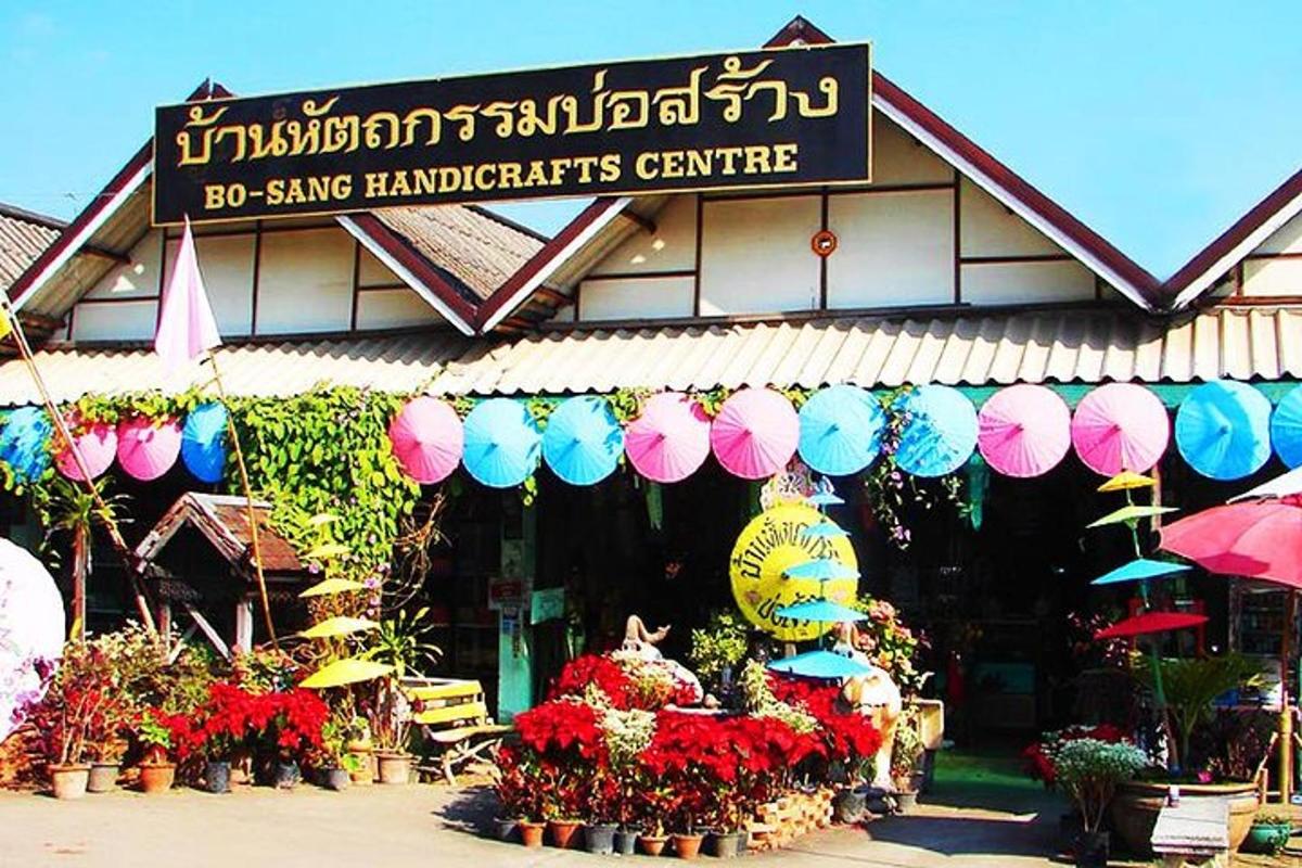 a store with flowers and umbrellas in front of it