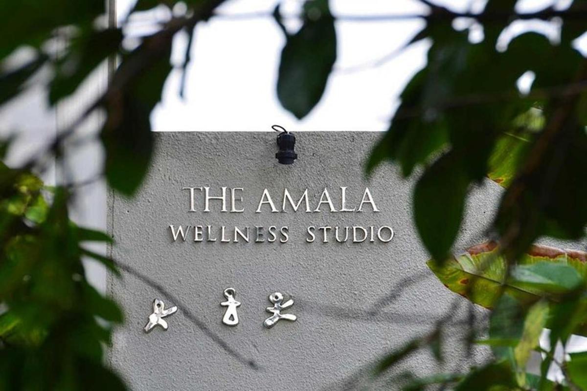 a sign that says the amala wellness studio