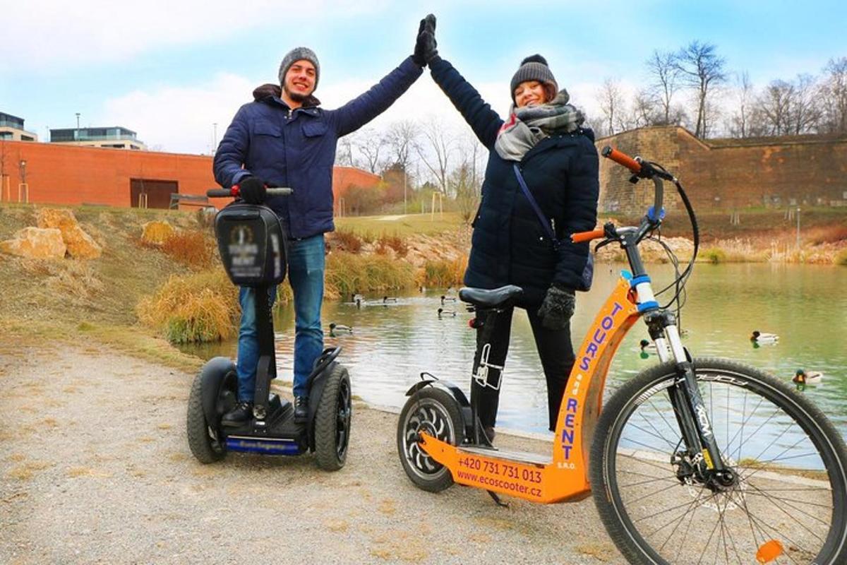 a man and a woman standing next to two scooters