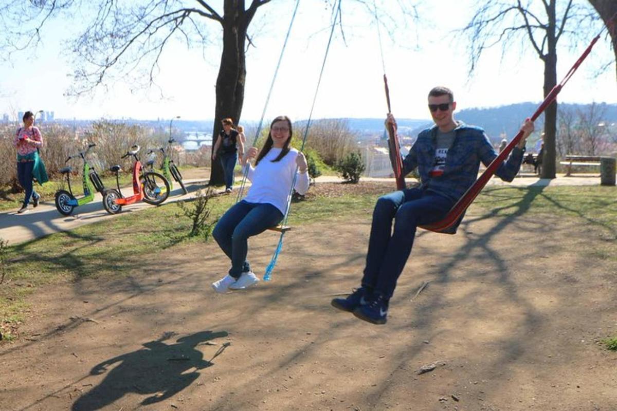 a man and a woman sitting on a swing