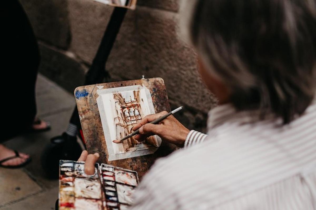 uma mulher está pintando um quadro de um edifício