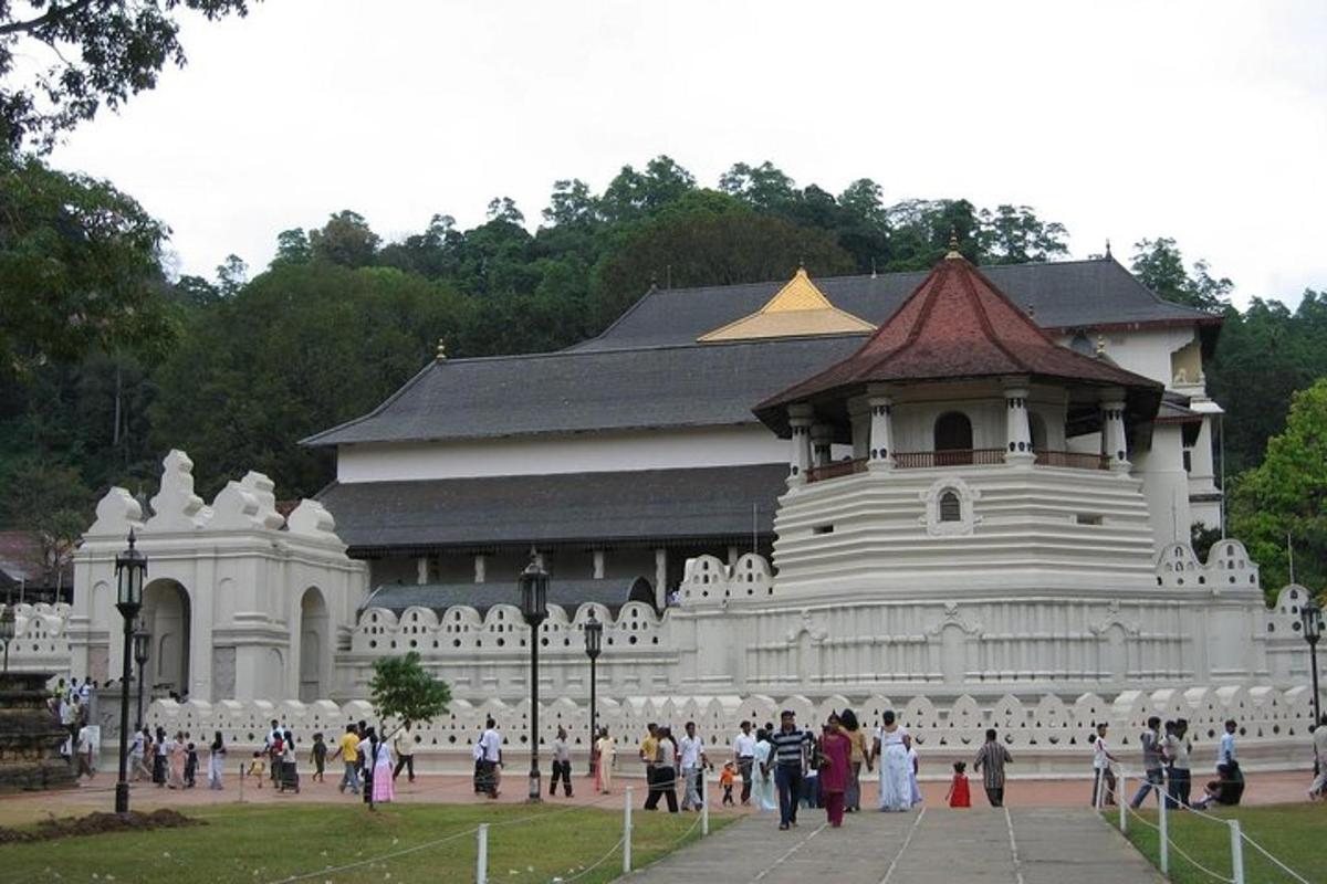 a large white building with people standing in front of it