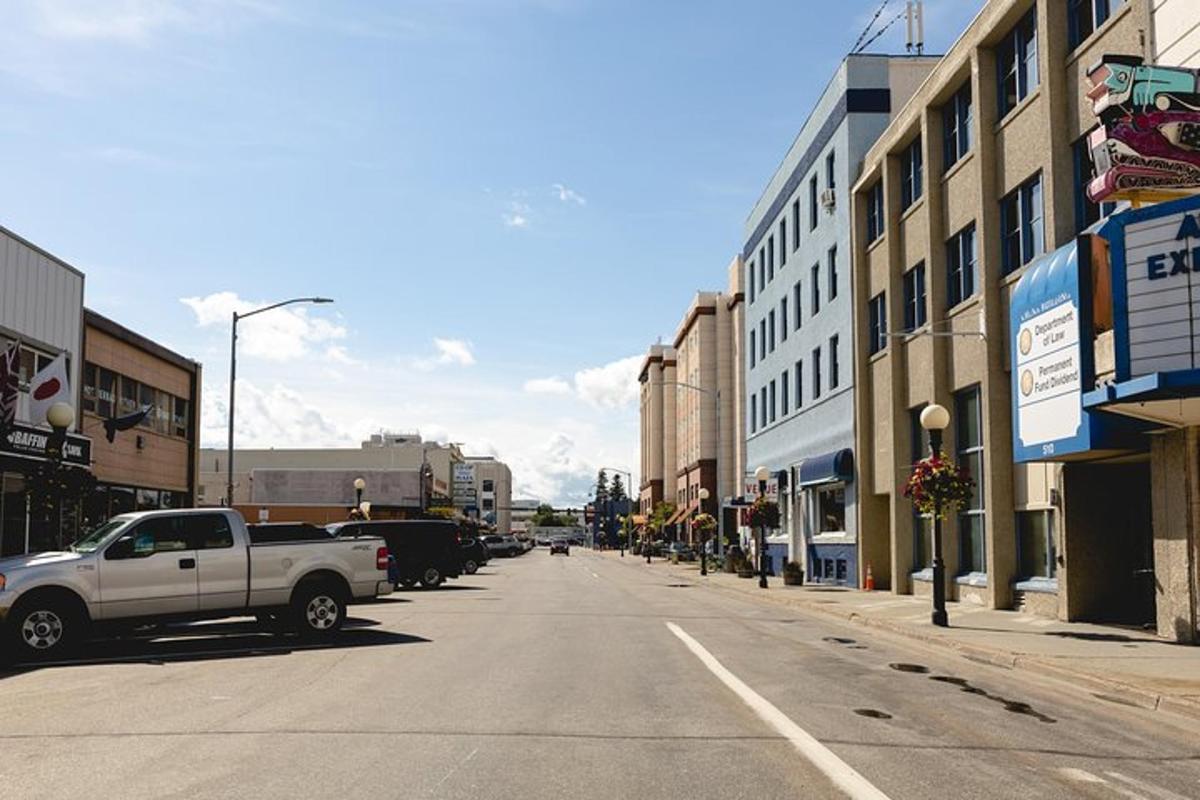 a white truck parked on a city street with buildings