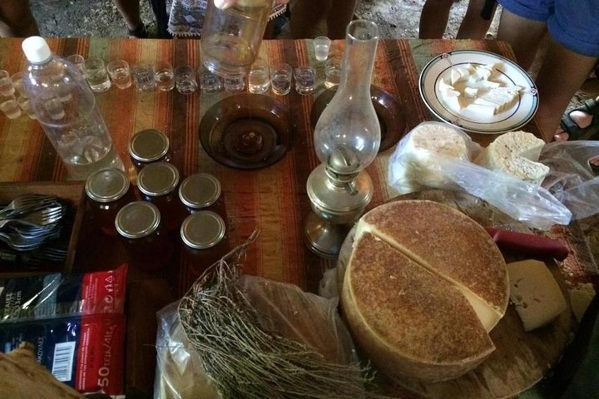 a wooden table topped with a table with food and glasses