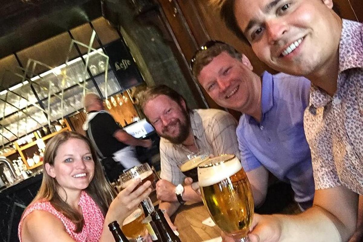 un gruppo di persone sedute al bar a bere birra