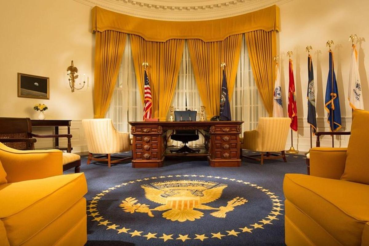 a large room with a desk in a room with flags