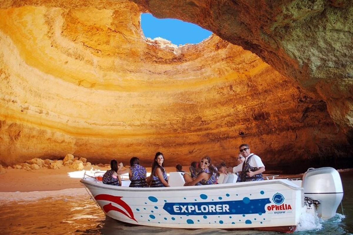 a group of people on a boat in front of a cave
