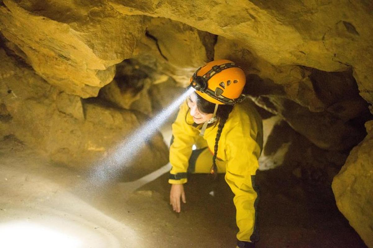 a man with a flashlight in a cave