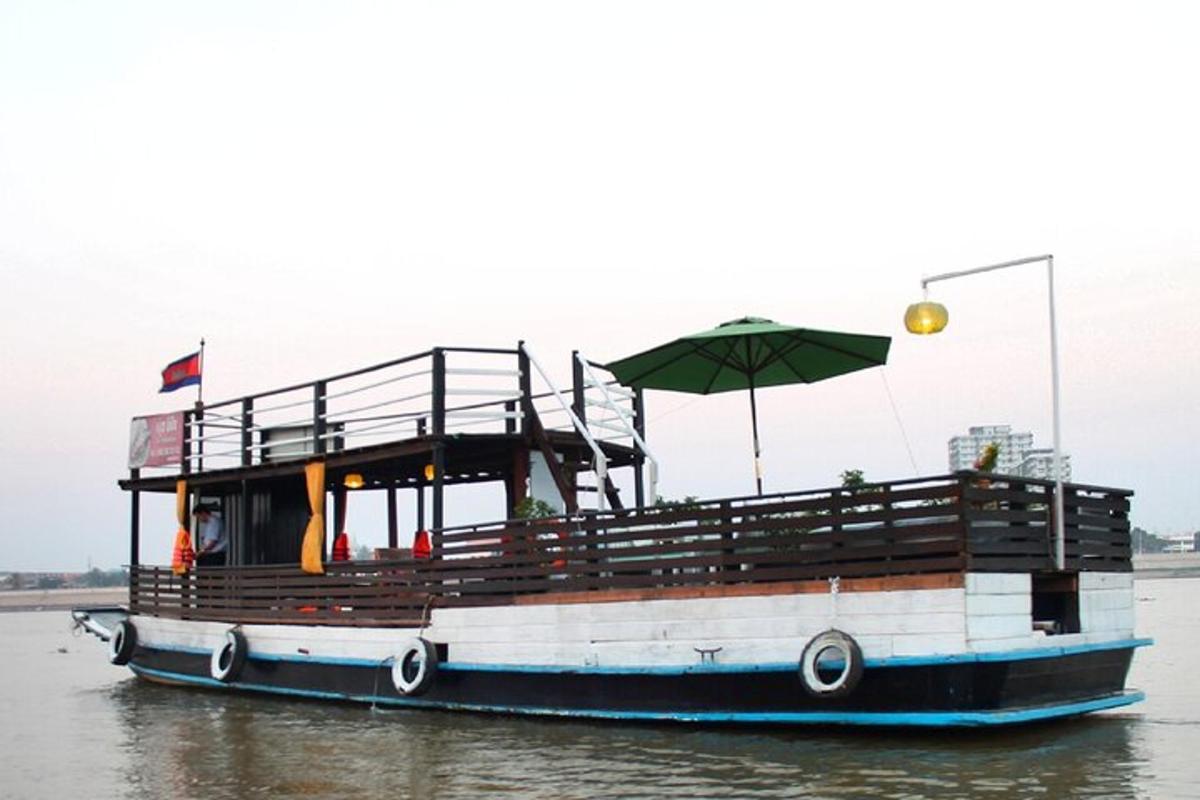 a boat with an umbrella on the water