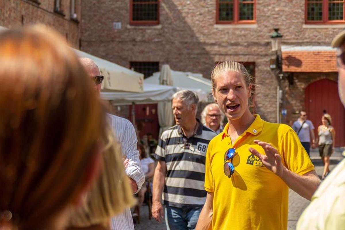 a man in a yellow shirt talking to a group of people