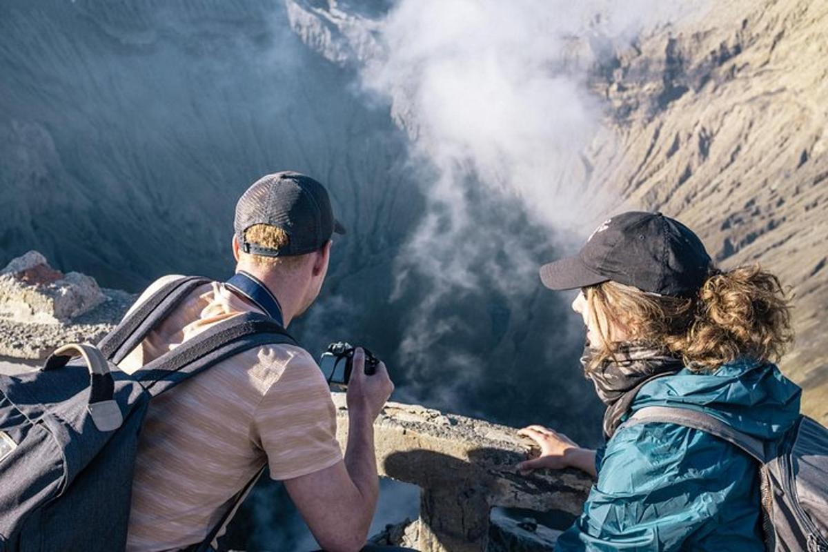 a man and a woman taking a picture of a mountain