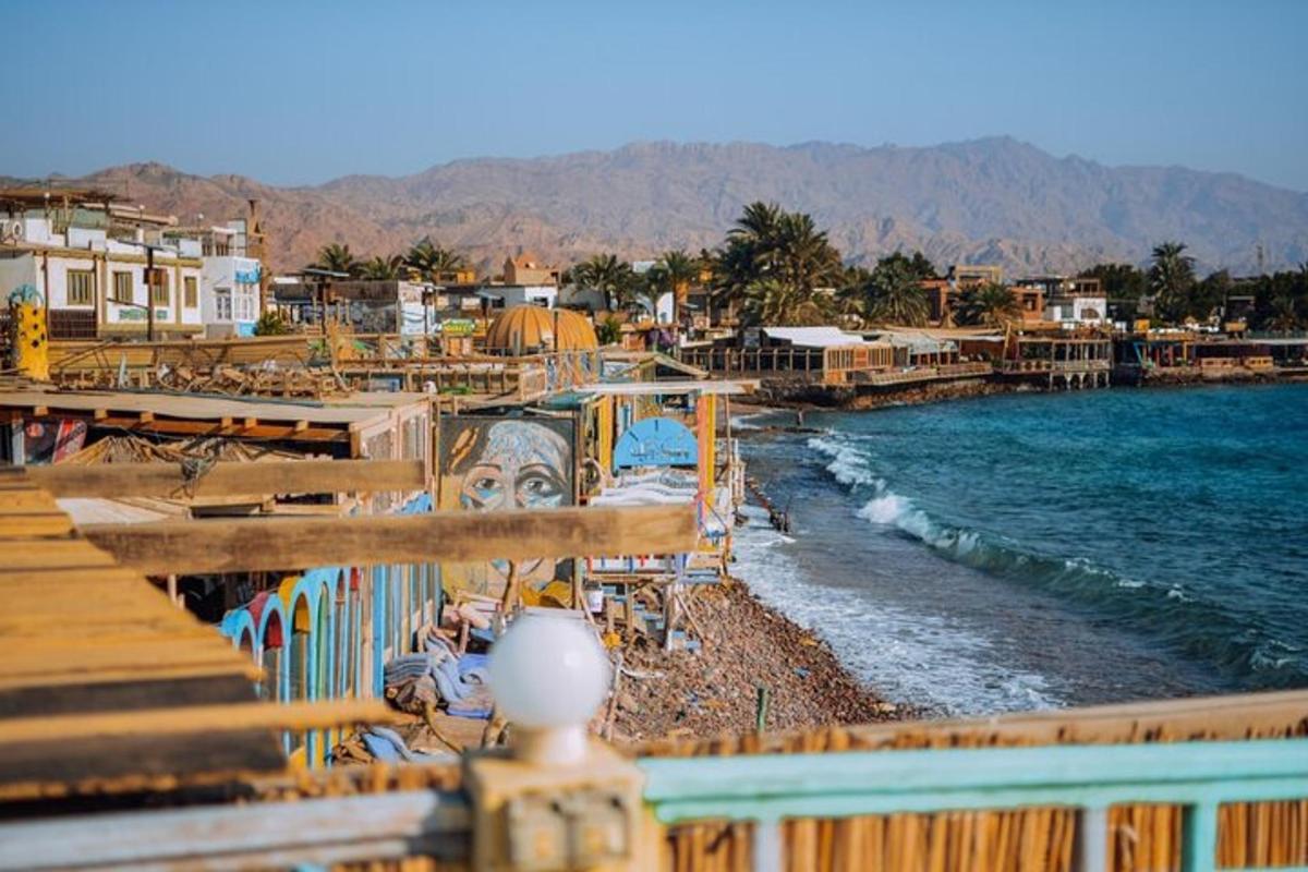 a view of a beach with houses and the water
