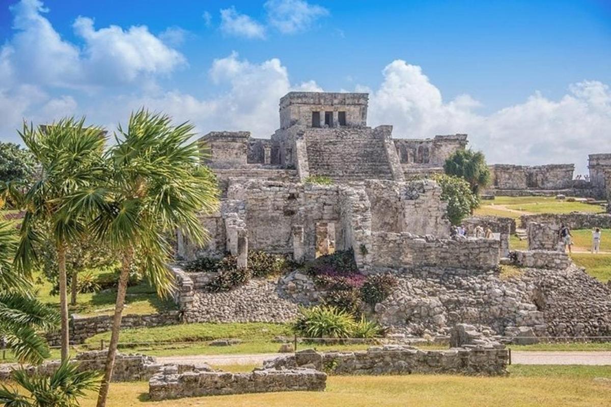 an old building with palm trees in front of it