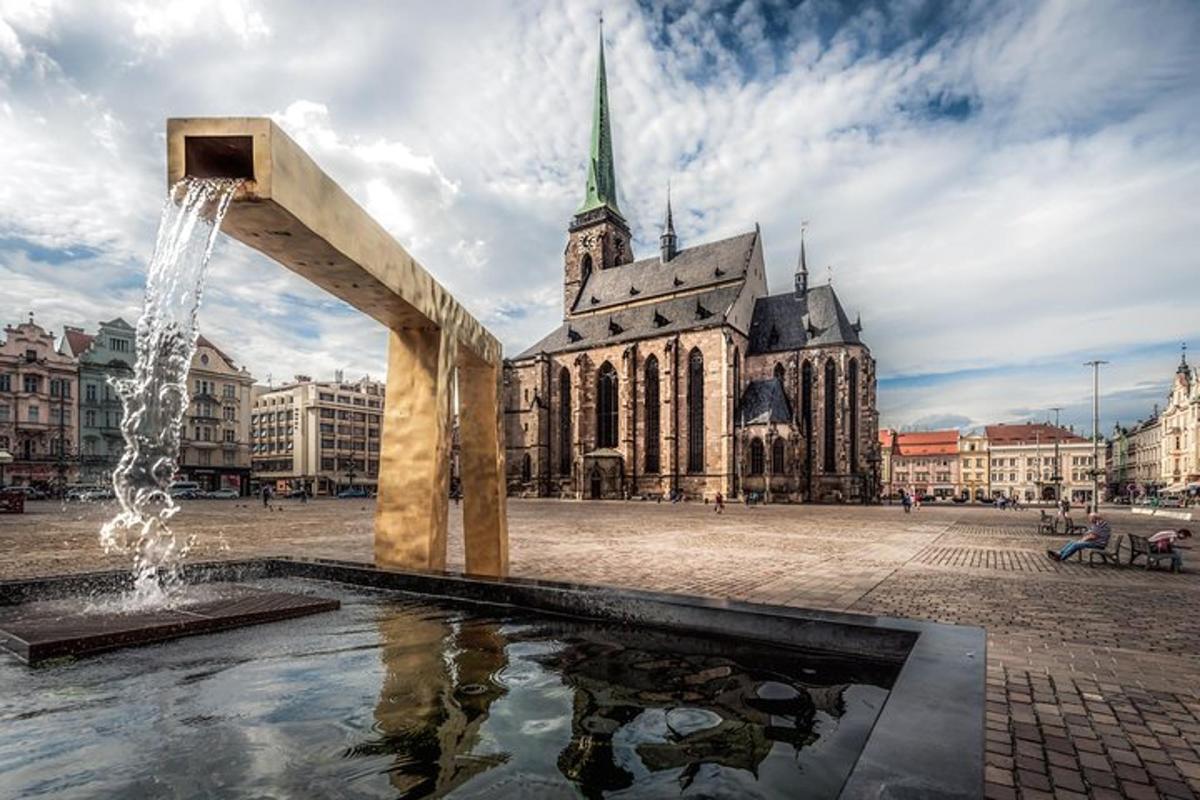 a fountain in front of a building with a church