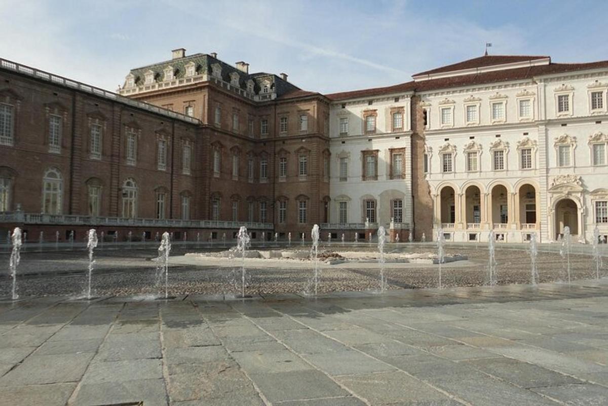 a large building with water fountains in front of it