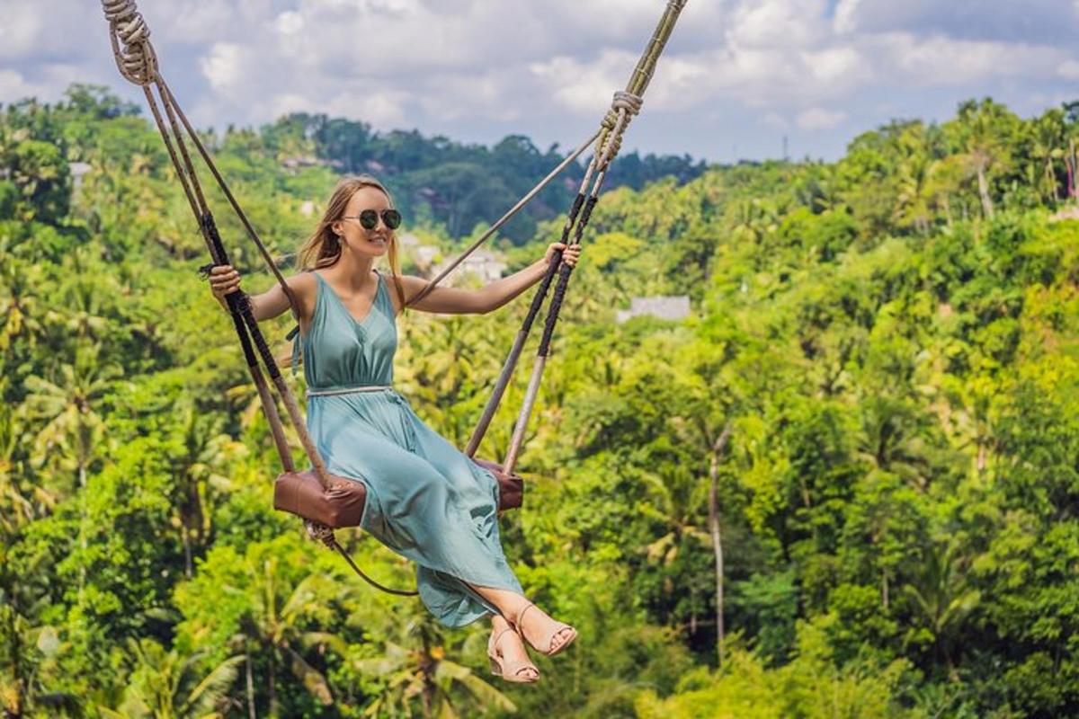 a woman in a dress swinging on a swing