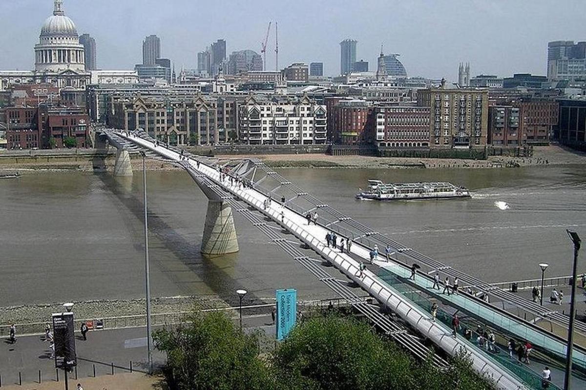 Un puente sobre un río con una ciudad al fondo