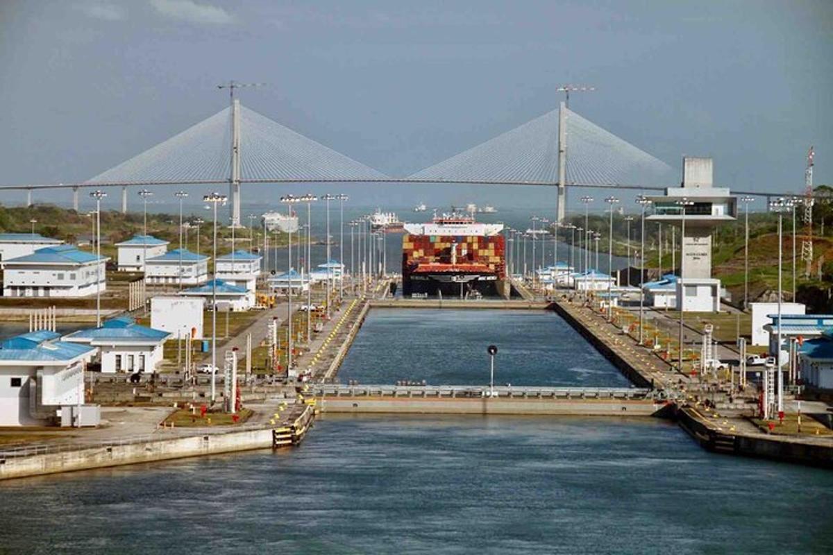 a large body of water with a bridge in the background