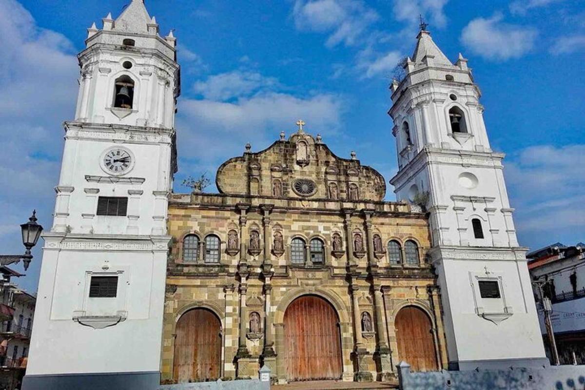 an old building with two towers with a clock on it
