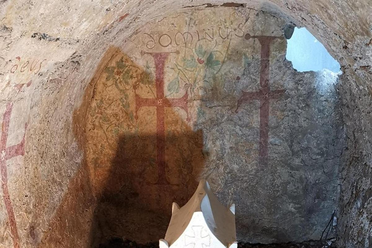 a cross painted on the side of a wall