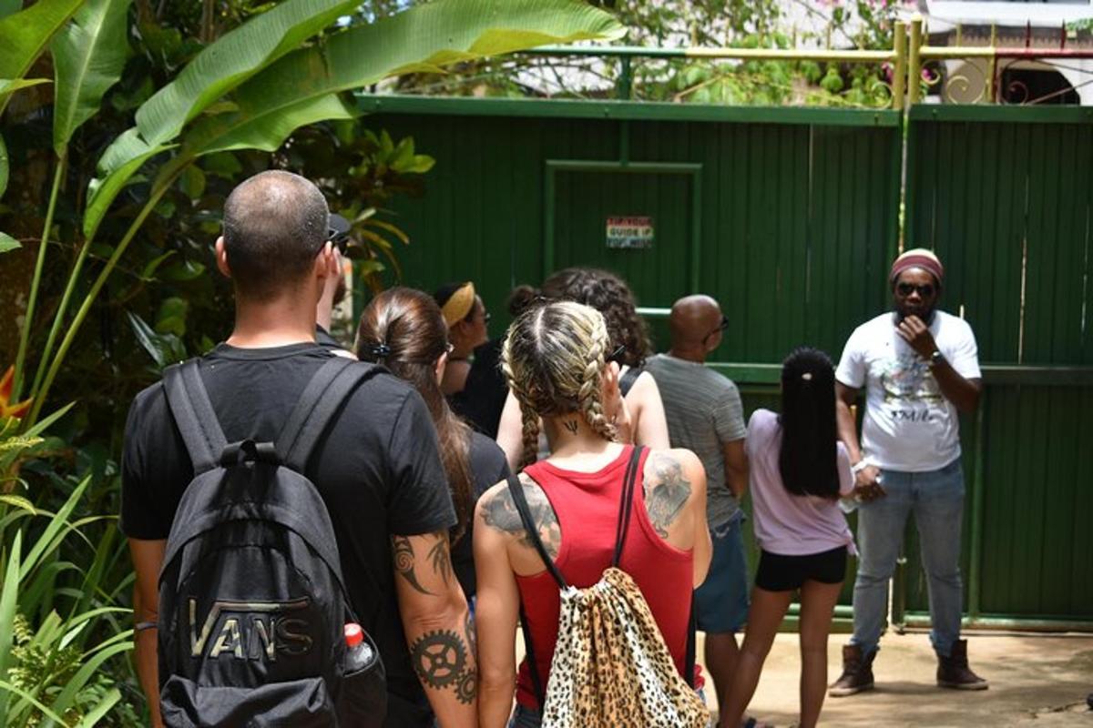a group of people standing in front of a green building